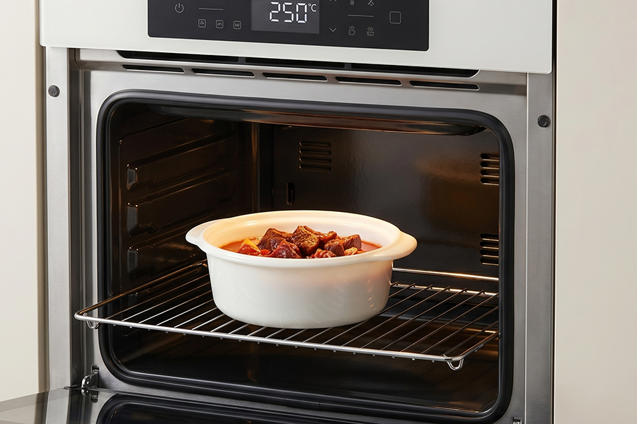 Elegant Opal Glass Casserole coming out of a modern oven